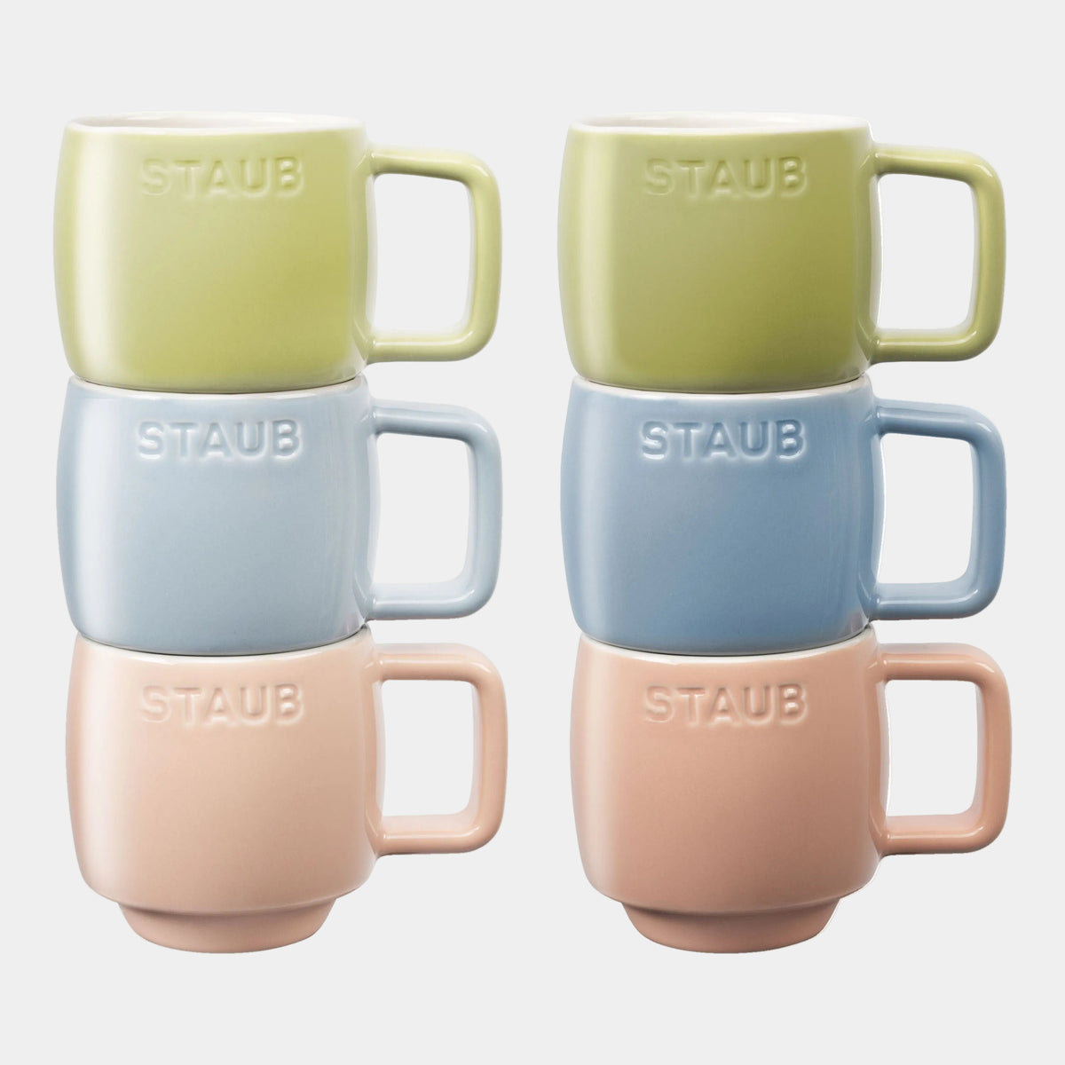 Set of four Staub mugs in different colors on a white background
