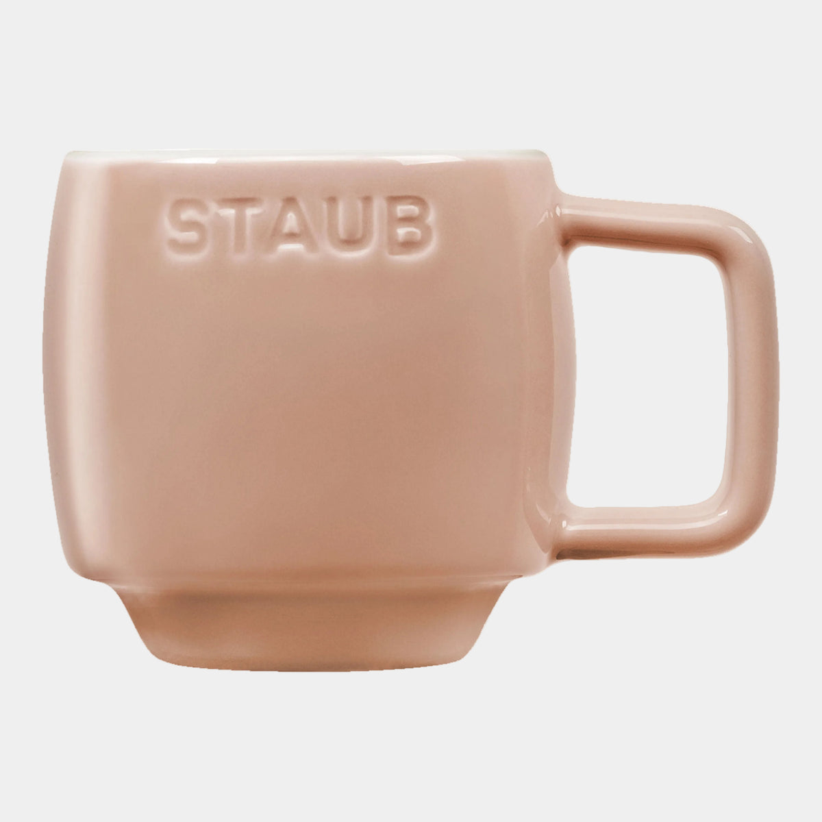 Pink mug with 'STAUB' branding on a white background