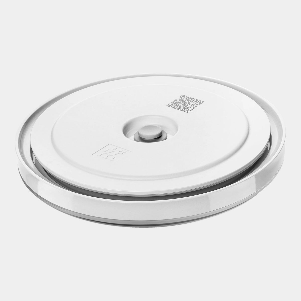 Round metallic object with a central button and brand logo on a white background