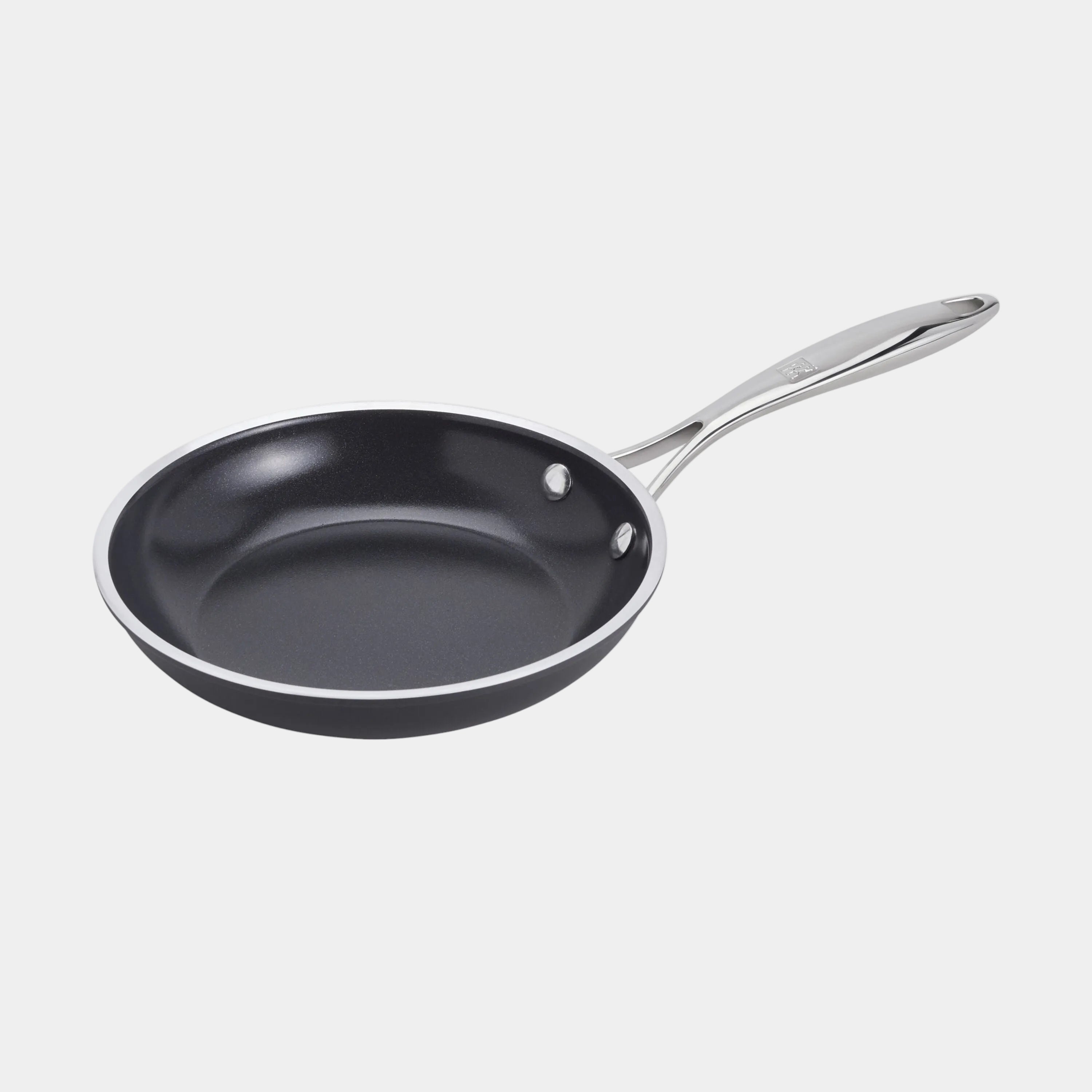 Black frying pan with a silver handle on a white background