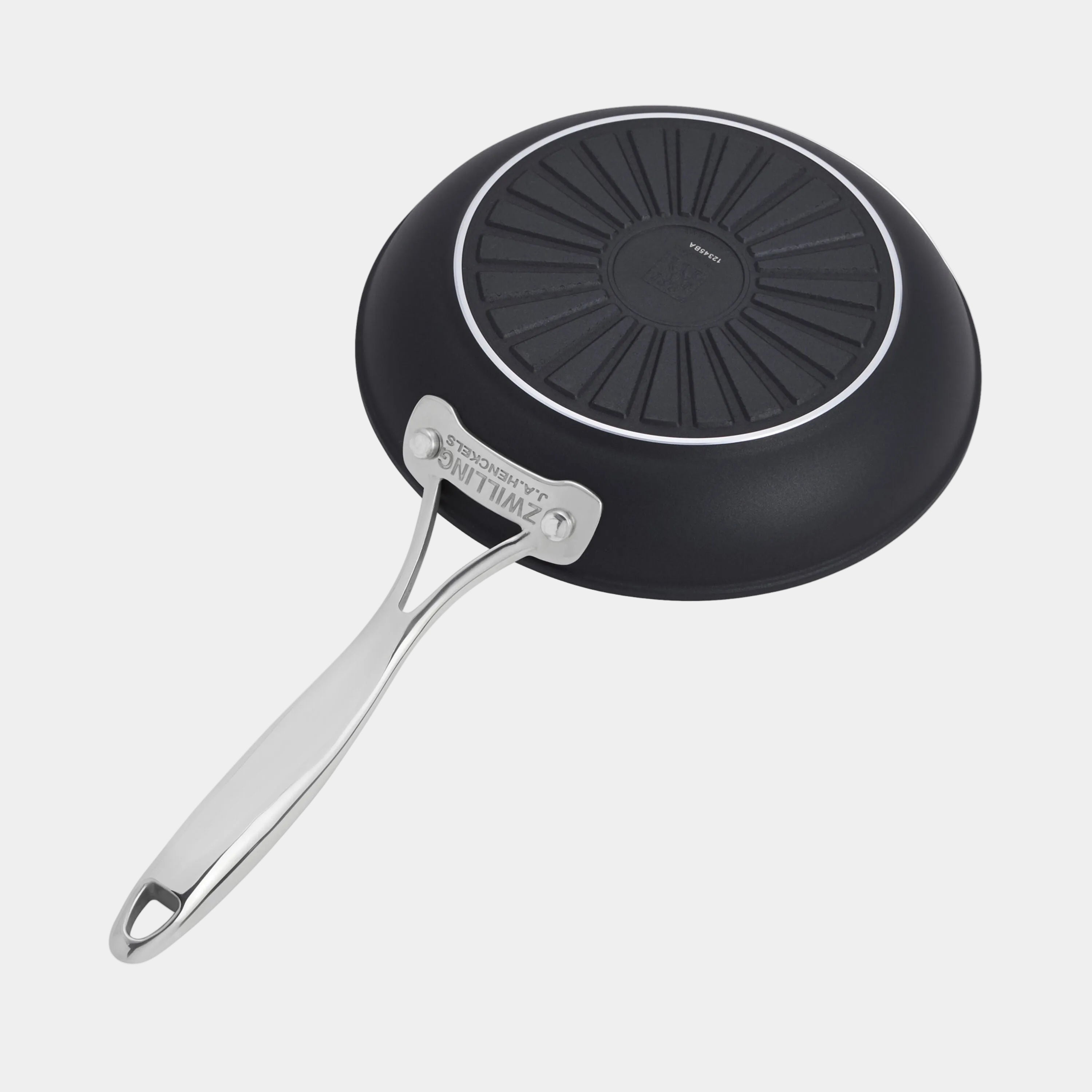 Black frying pan with a ribbed bottom and silver handle on a white background