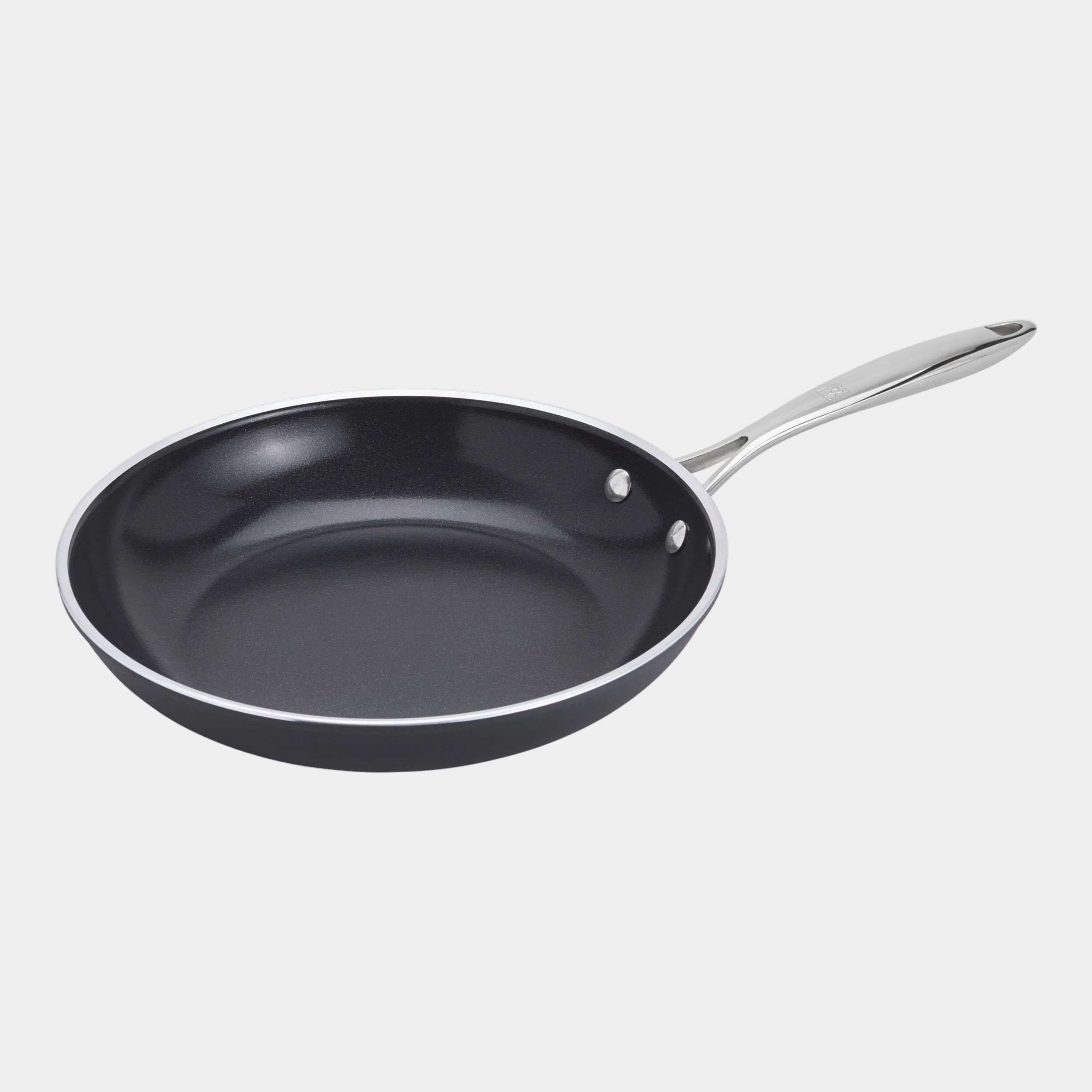 Black frying pan with a silver handle on a white background