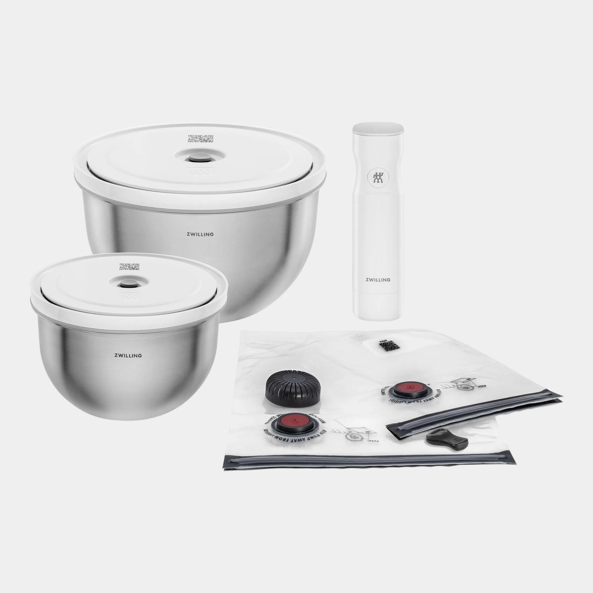 Set of stainless steel kitchen items including bowls, a bottle, and a mat on a white background.