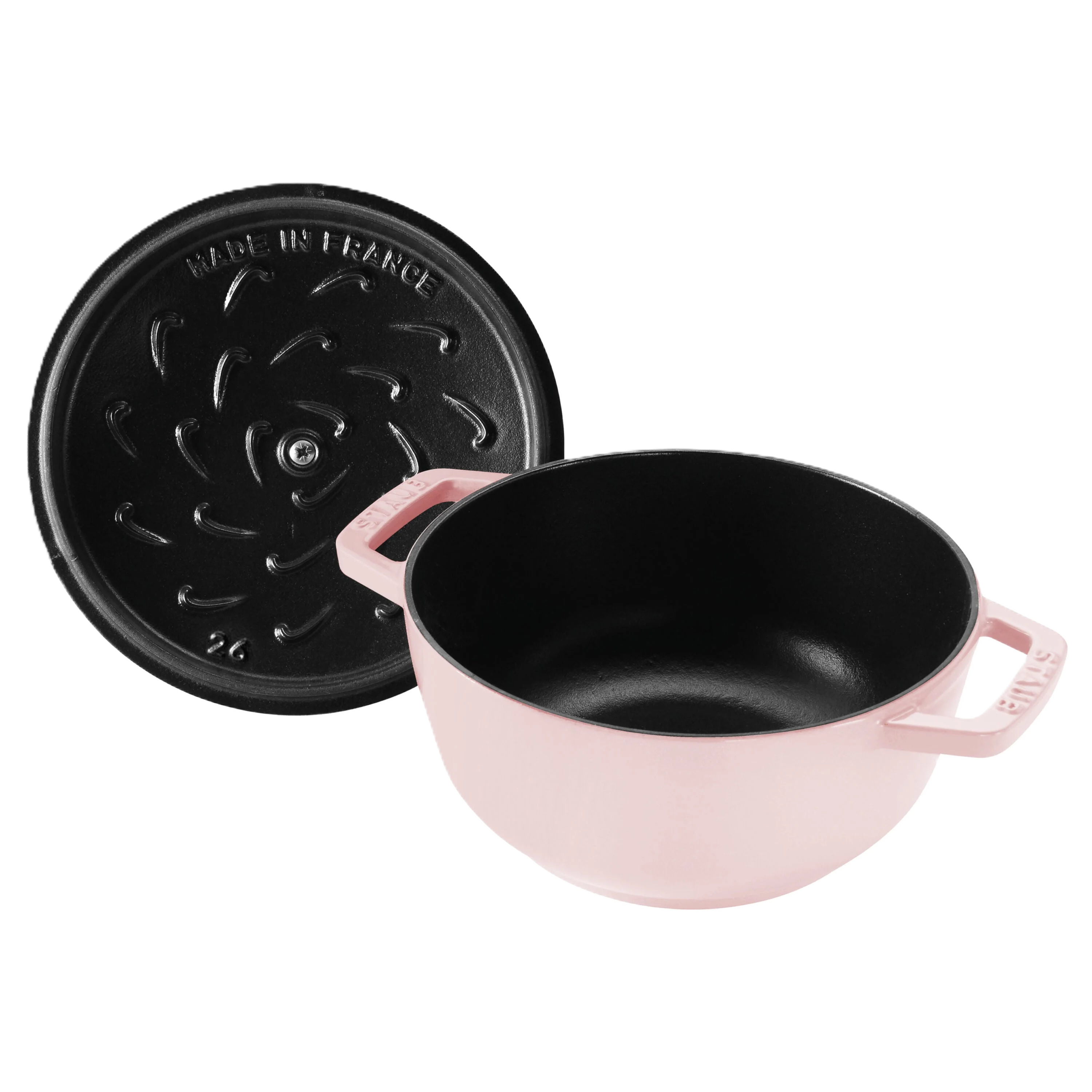 Pink enameled cast iron cookware set with black lid on a white background