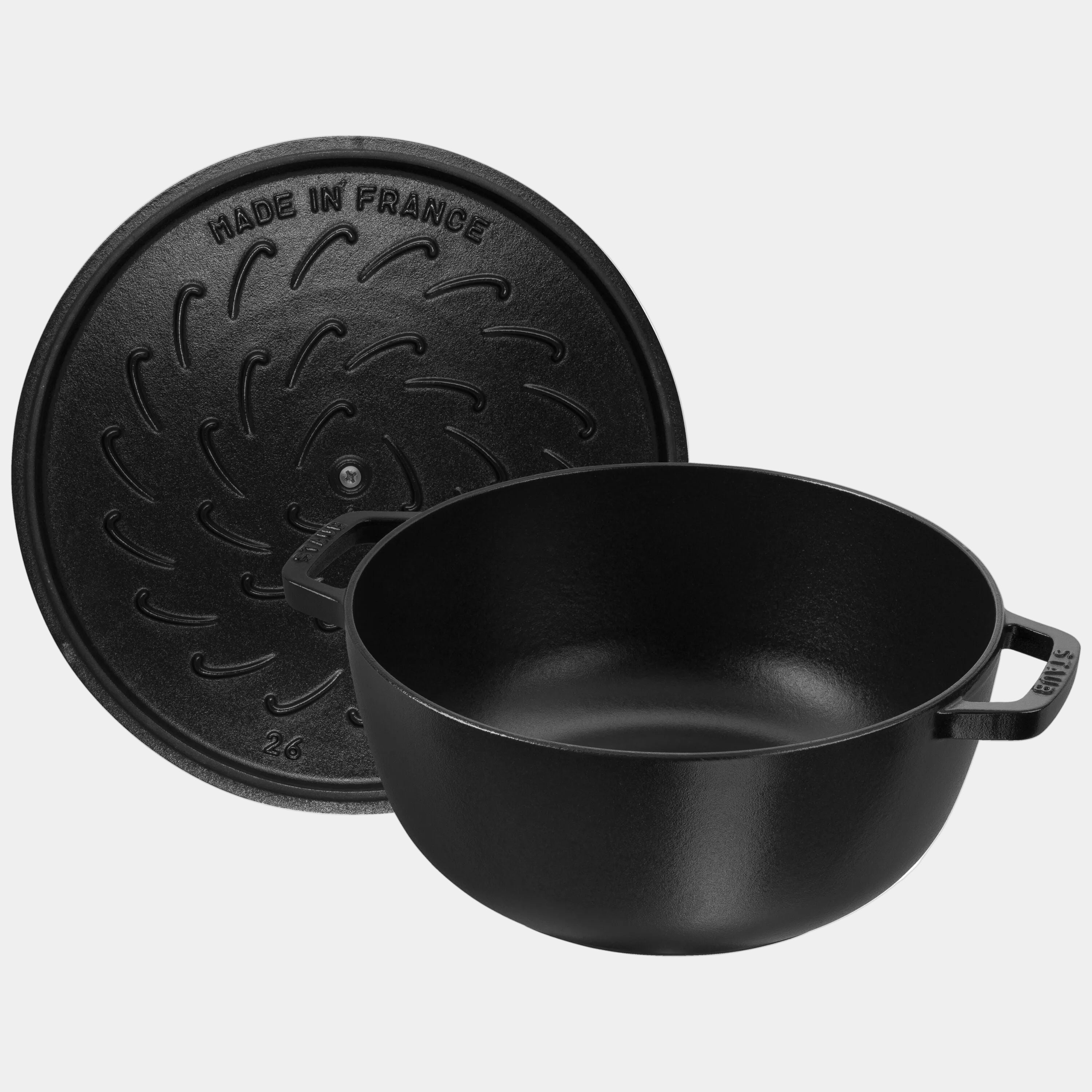 Black cast iron pot with lid on a white background
