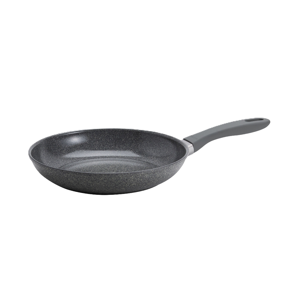 Black frying pan with speckled texture on a white background