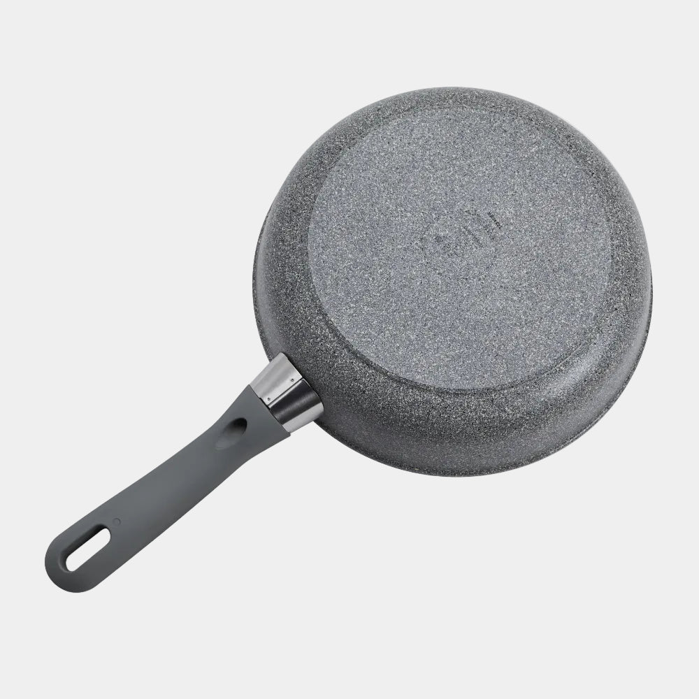 Gray frying pan with textured surface on a white background
