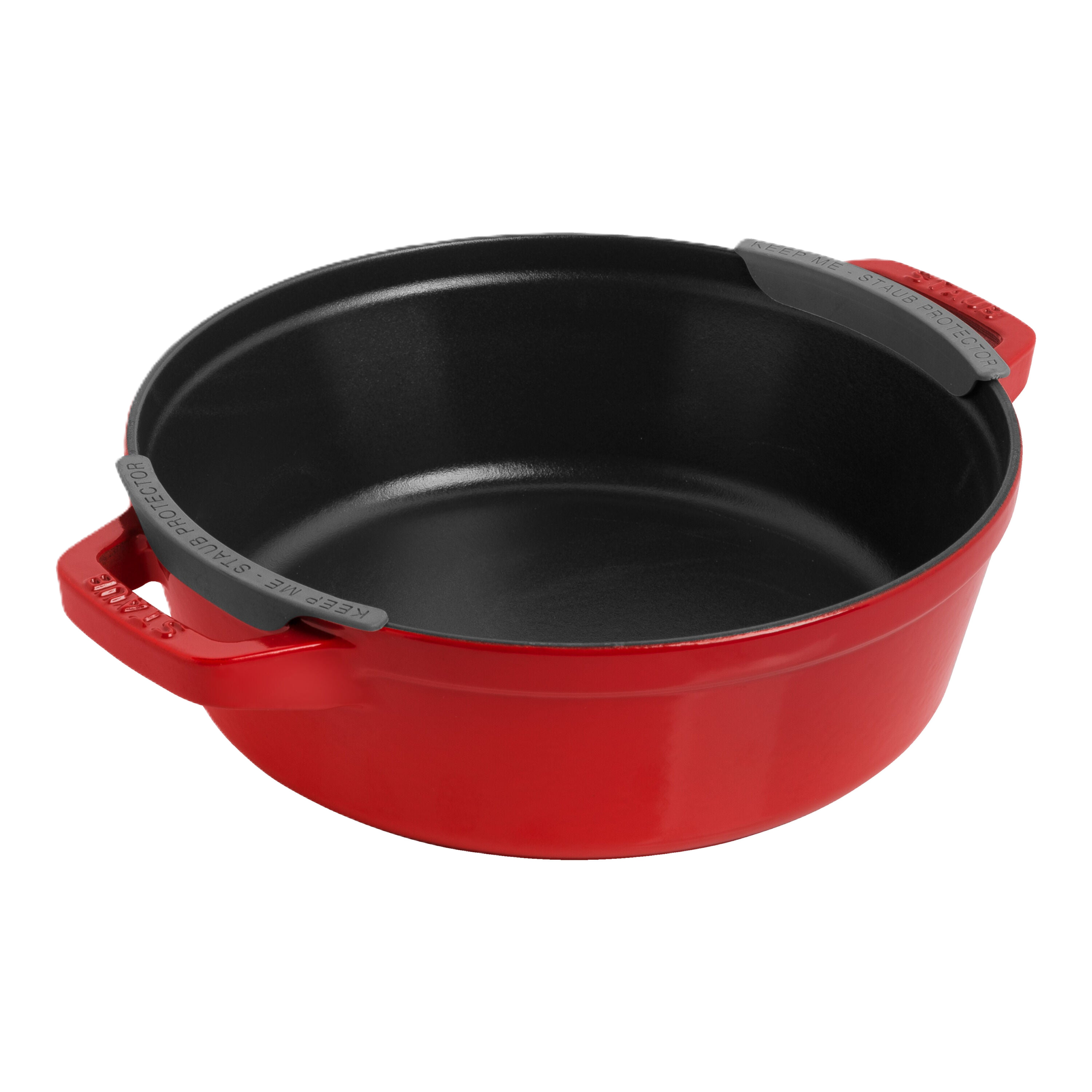 Red cast iron skillet with black interior on a white background