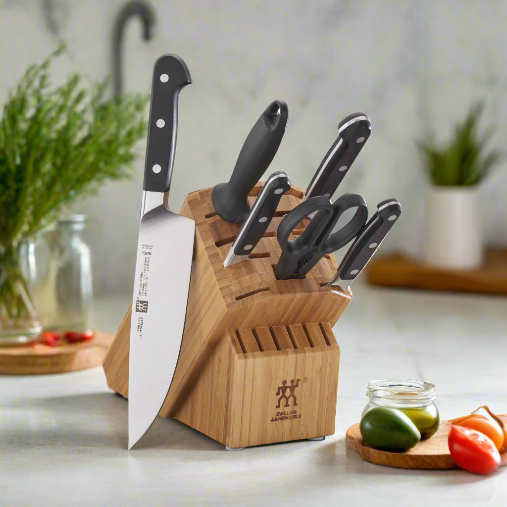 ZWILLING Pro 7 Piece, Knife Block Set, Bamboo with chef's knife and scissors on a kitchen countertop.
