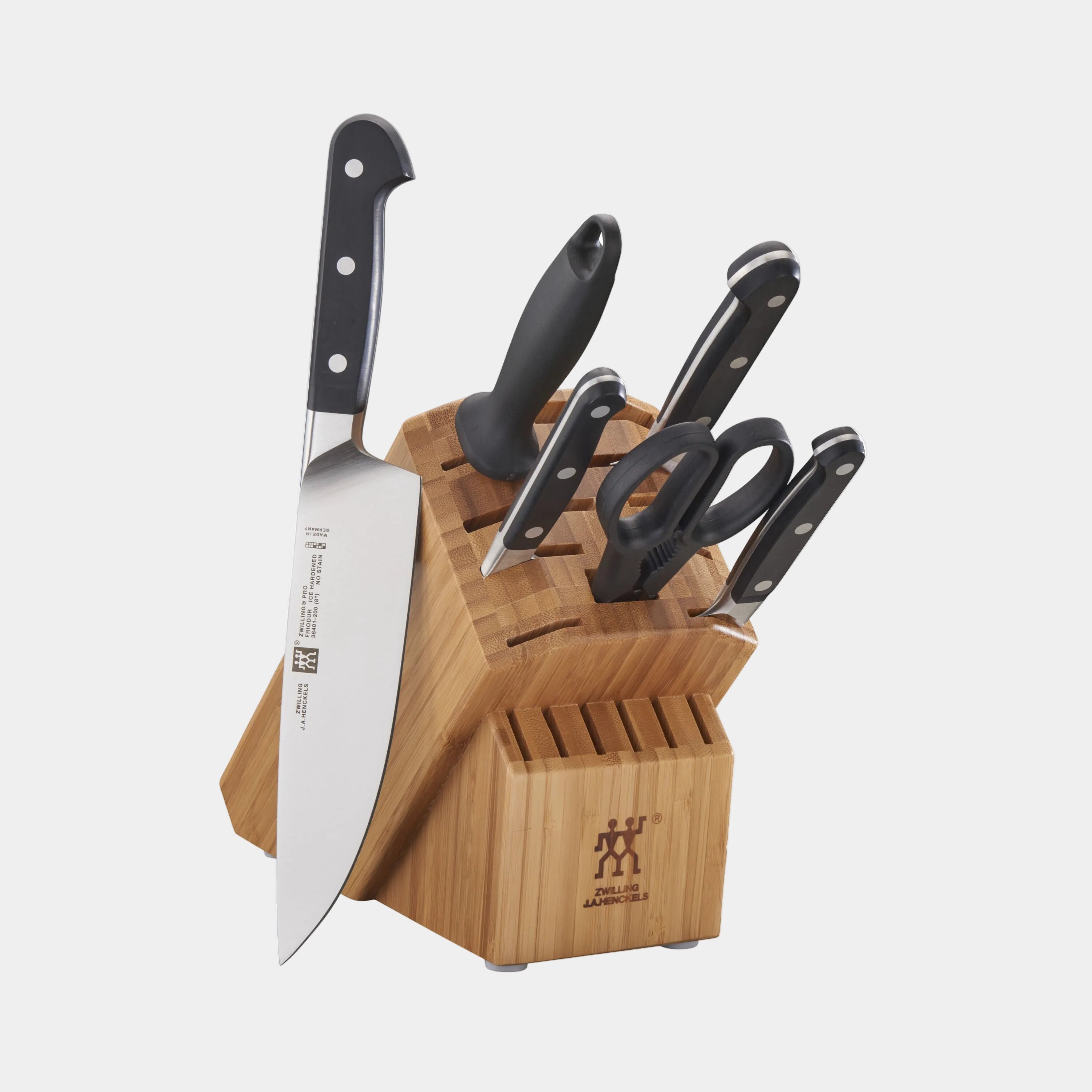 Set of knives in a wooden block on a white background