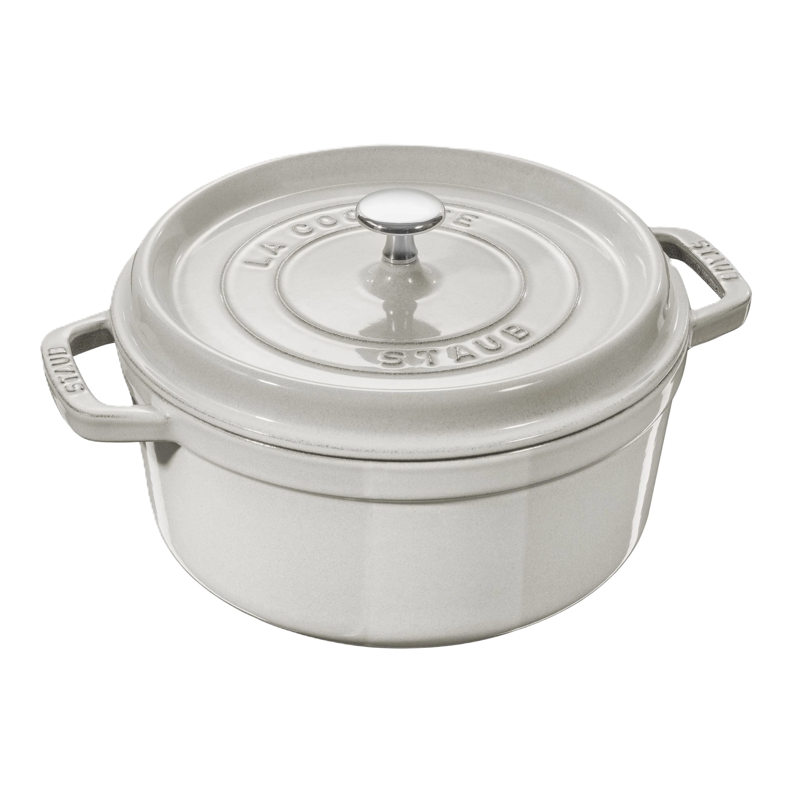 White Staub cocotte with a clear glass lid on a white background