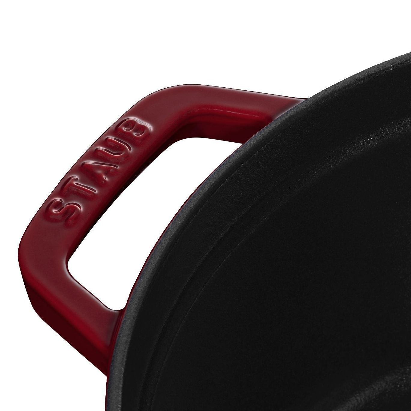 Close-up of a red-handled cast iron skillet on a white background