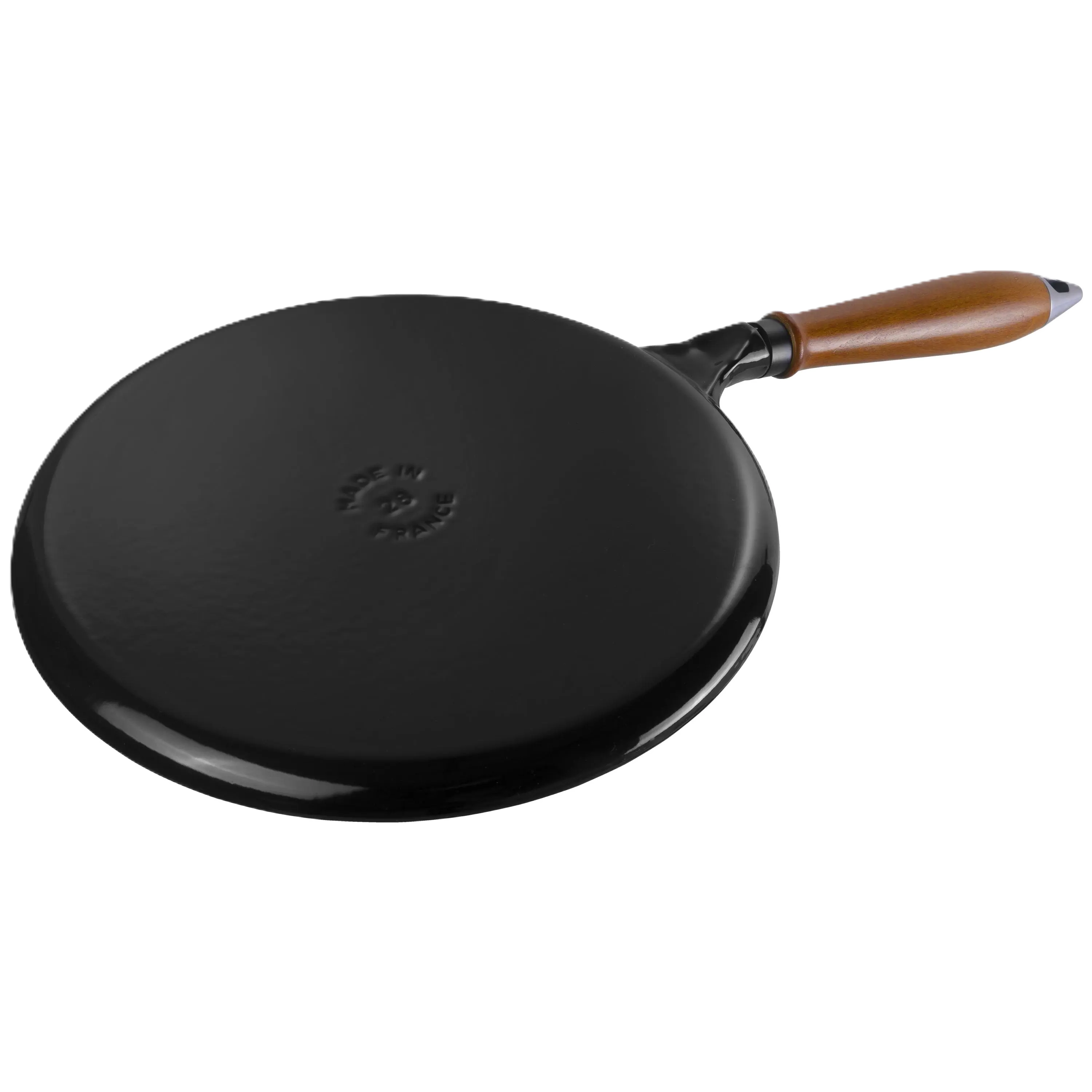 Black frying pan with a wooden handle flipped on a white background