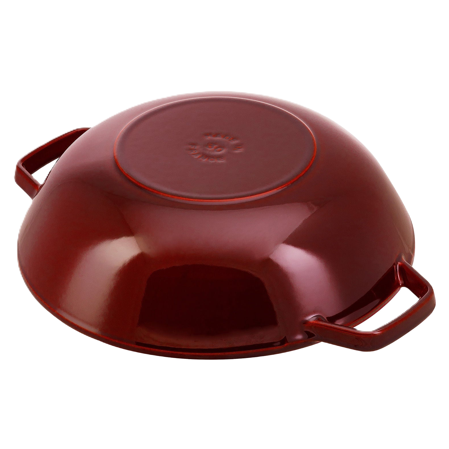 Red enameled cast iron skillet on a white background