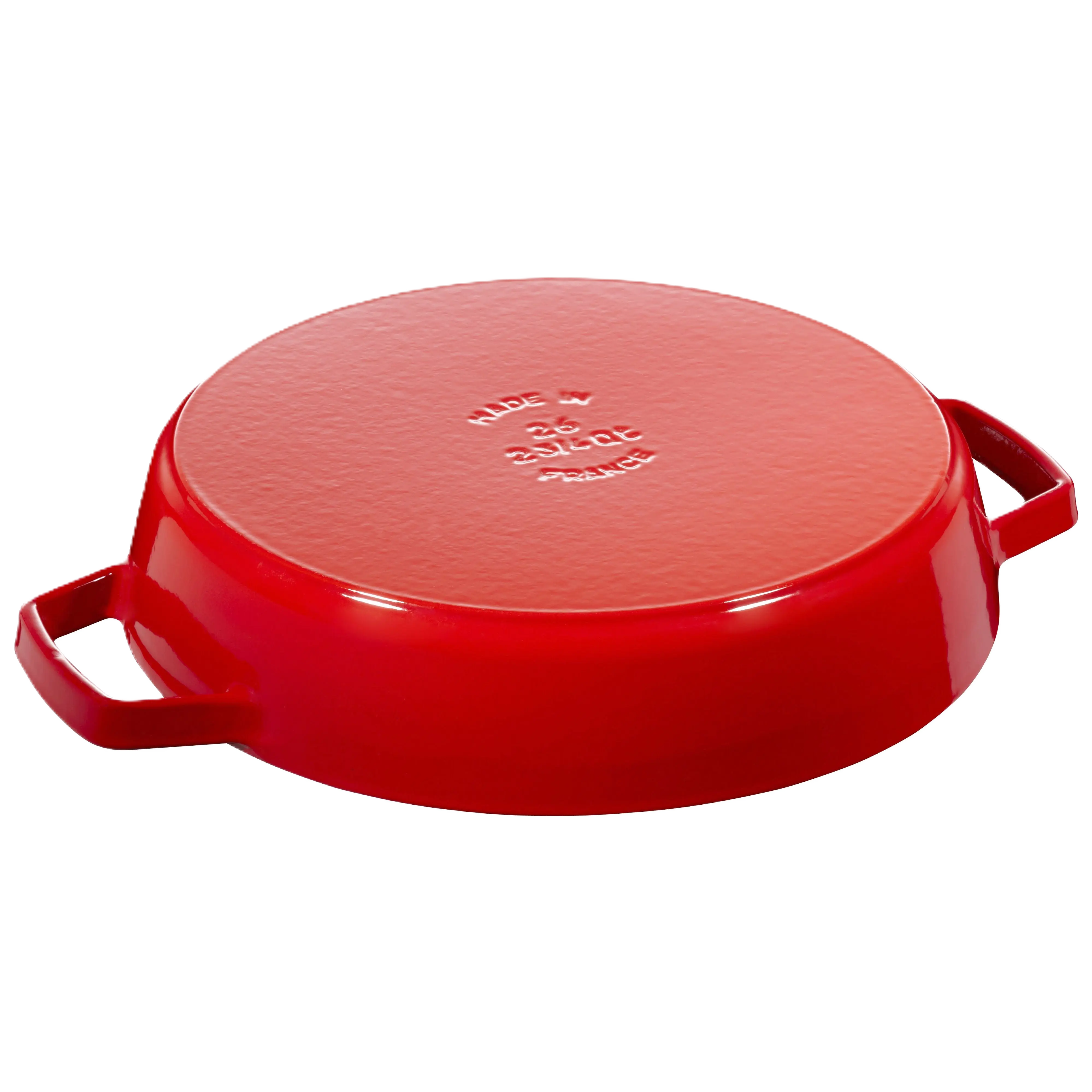 Red cast iron skillet with lid on a white background