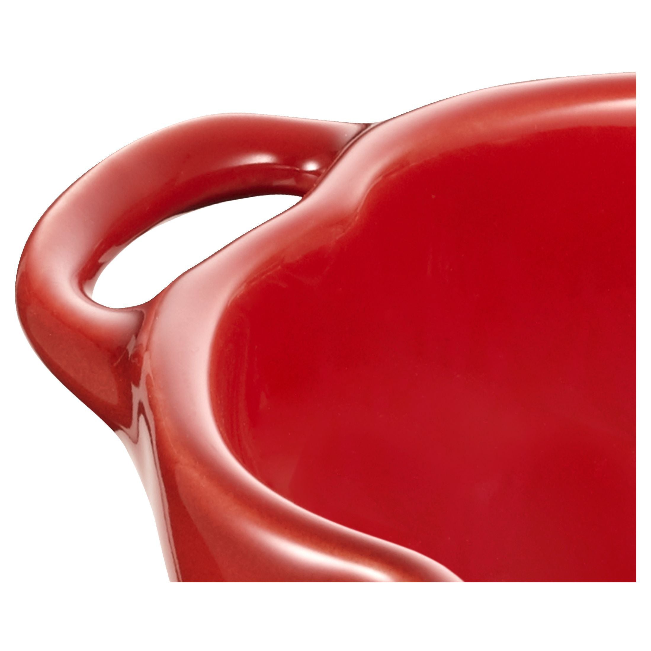 Close-up of the handle of the STAUB Ceramique Ceramic Tomato Cocotte, showcasing its vibrant cherry red color.