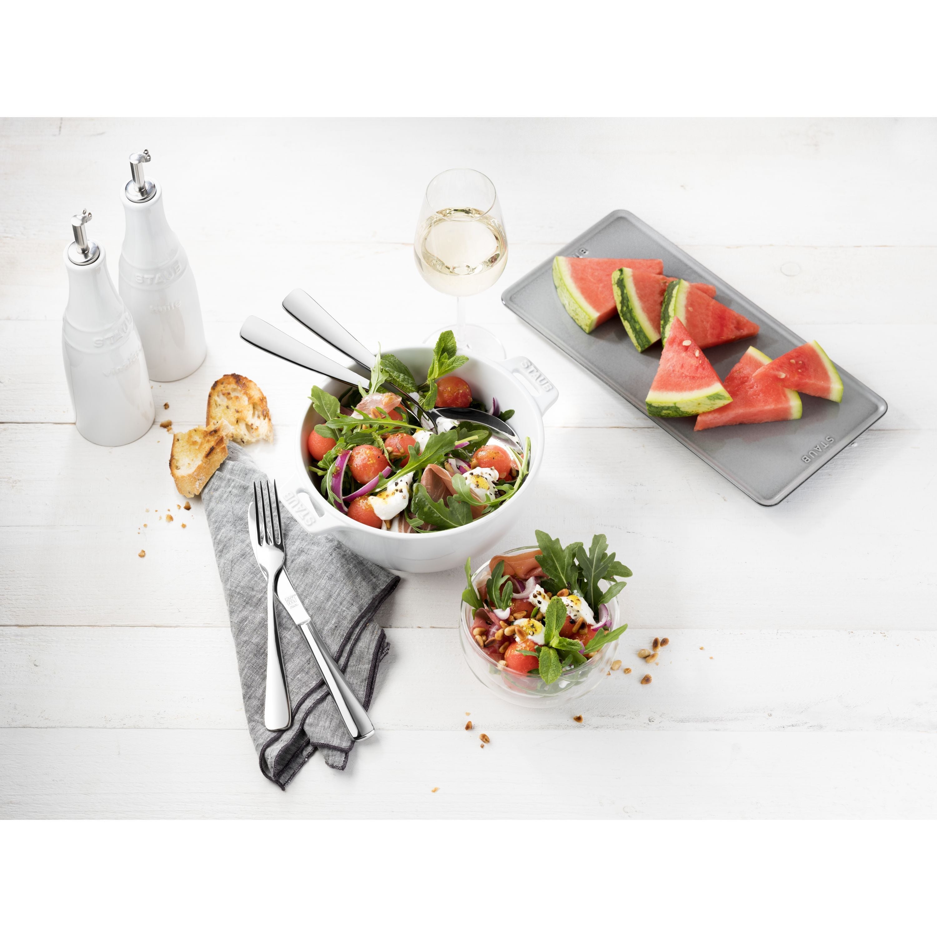 Salad with watermelon slices on a white table