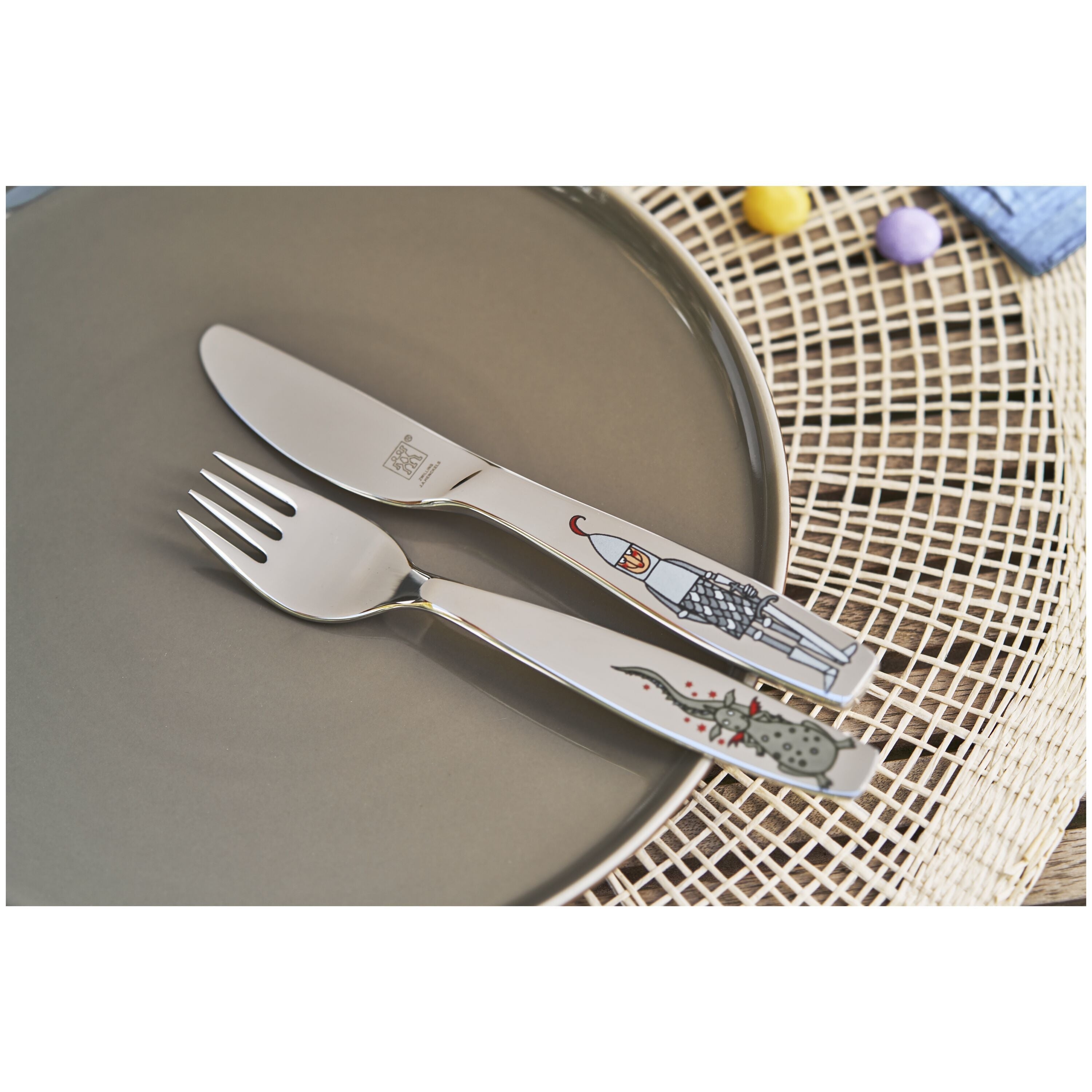 Children's cutlery set with cartoon design on a plate