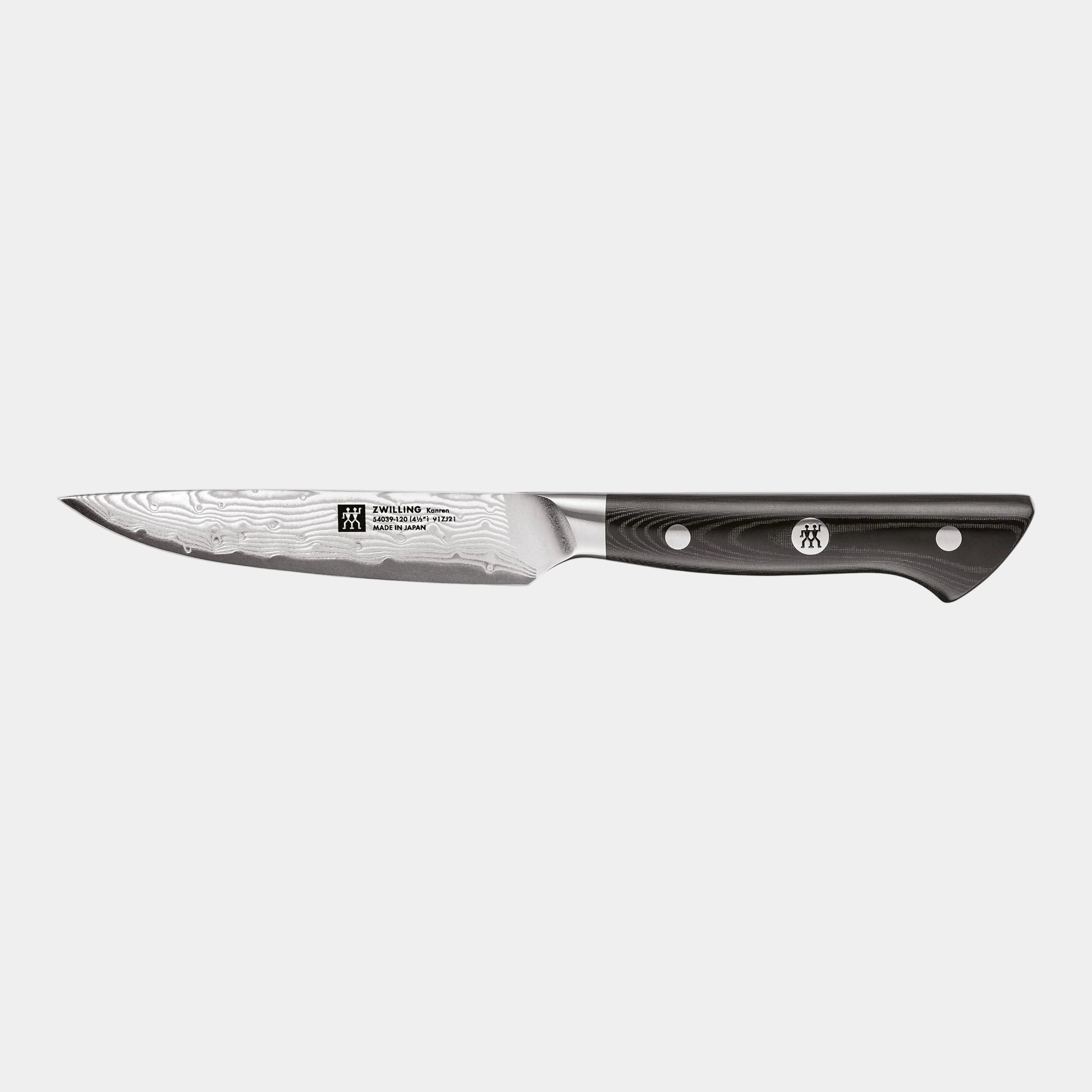 Paring knife with black handle on a white background