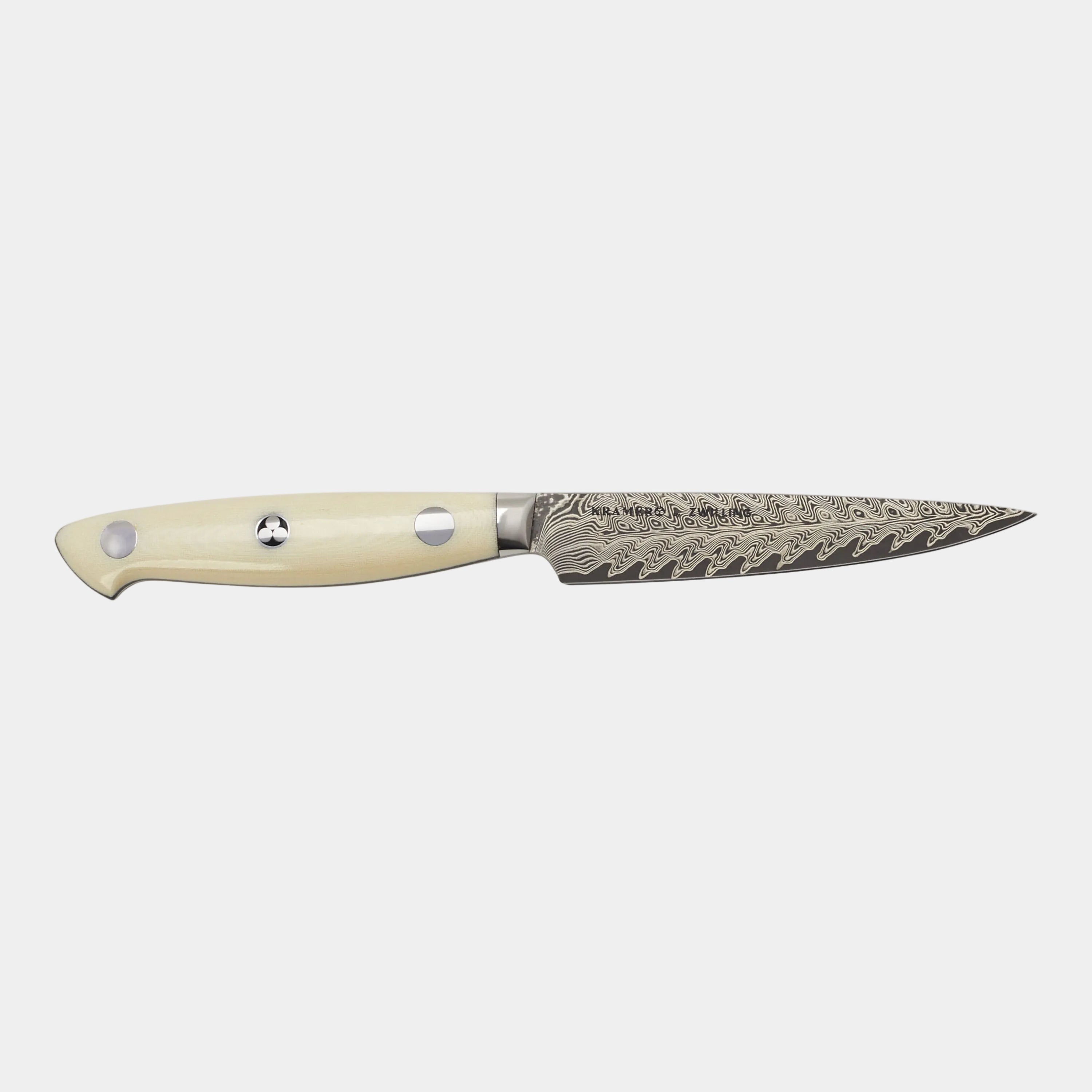 Decorative knife with a cream handle on a white background