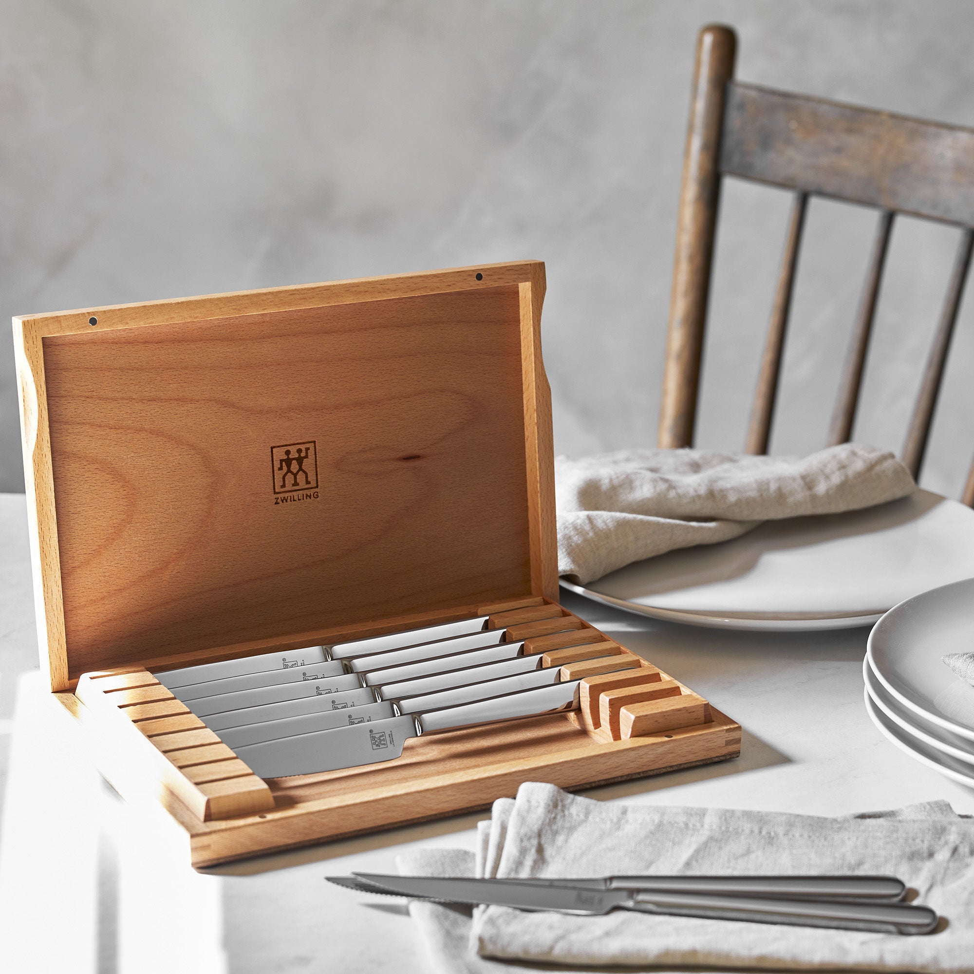 ZWILLING Contemporary Steak Knifes Set 8 Piece in elegant wooden case on dining table.