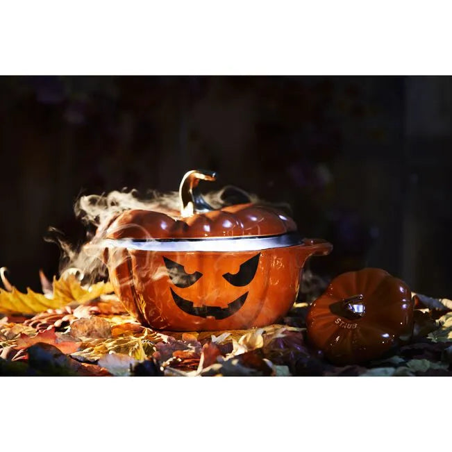 Ceramic pot shaped like a jack-o'-lantern with smoke effect on a dark background