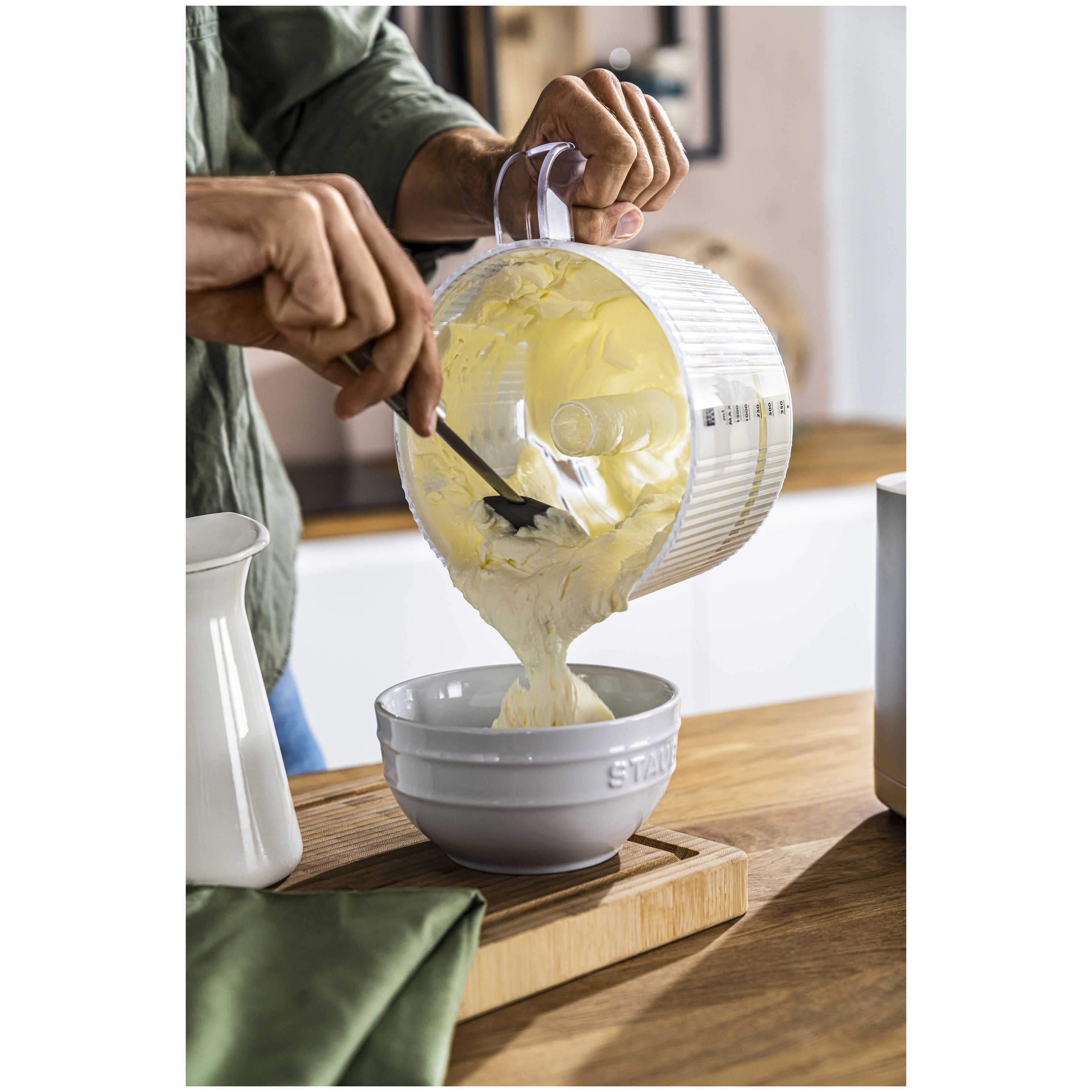 ZWILLING Enfinigy Food Processor Attachment blending ingredients into a bowl on a kitchen counter.