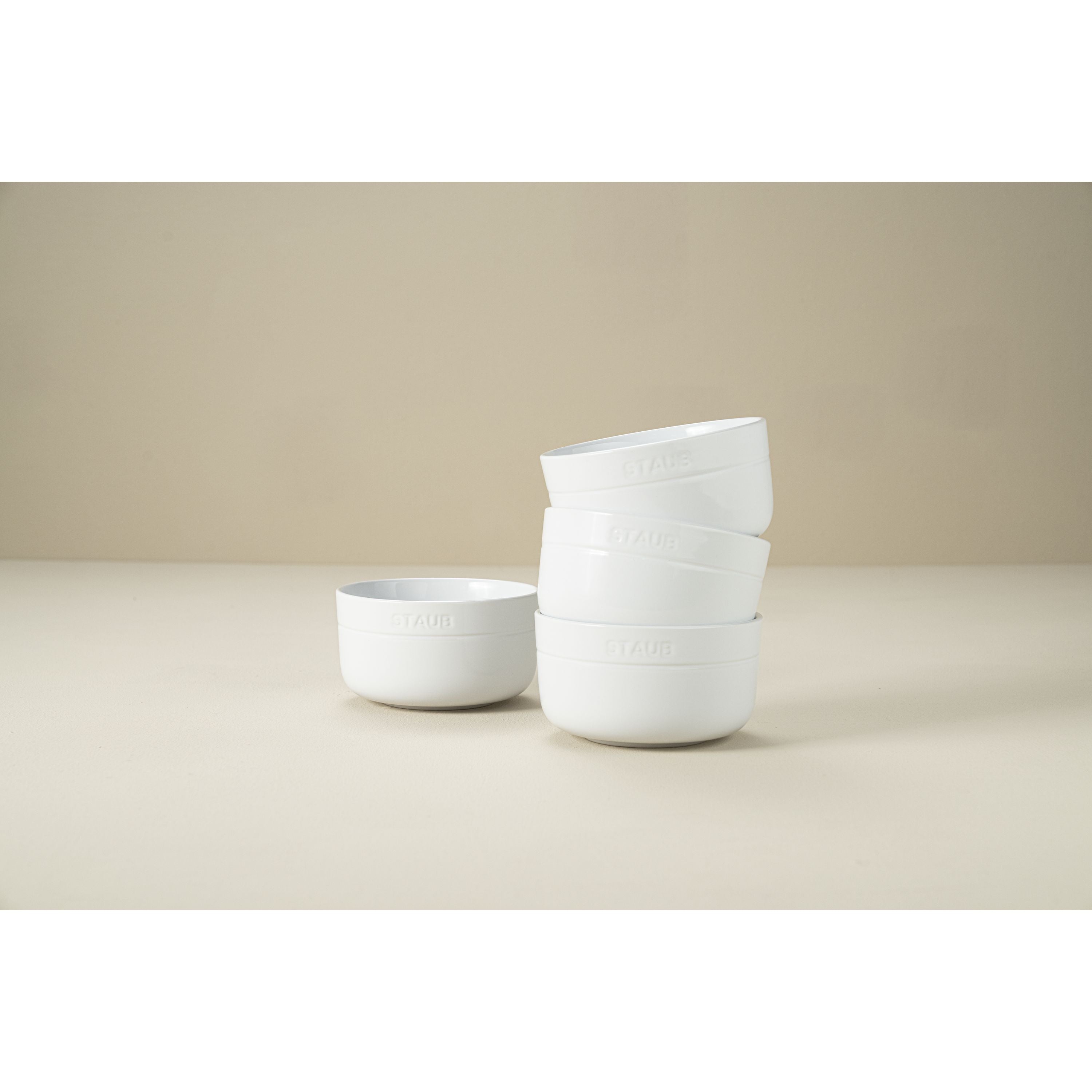 STAUB Dining Line 4 Piece Ceramic Bowl Set, White displayed in a stack of four durable stoneware bowls.